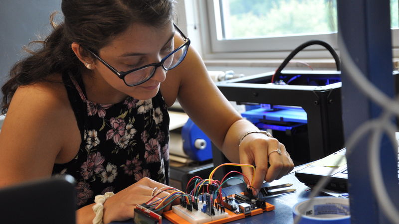 female student using 3-D printer female student using 3-D printer