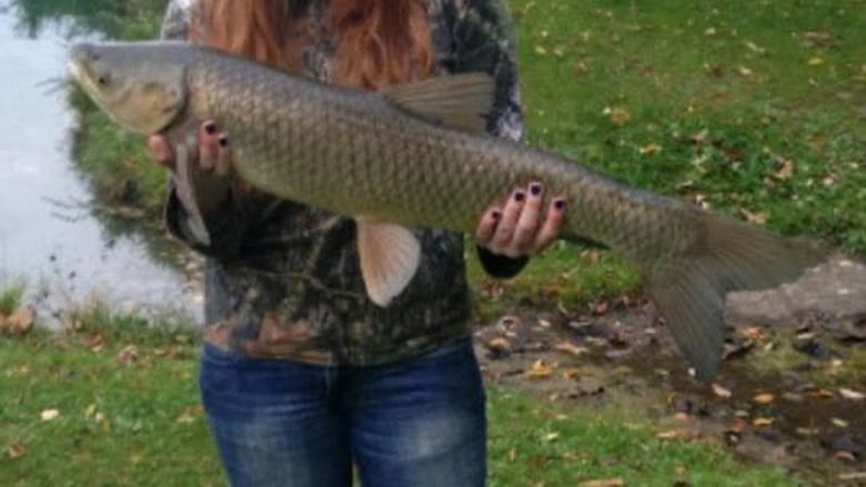 student holding large fish