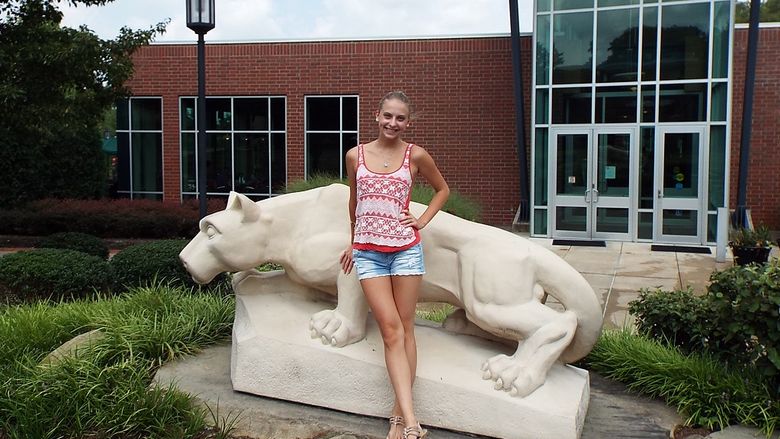 girl in front of lion statue