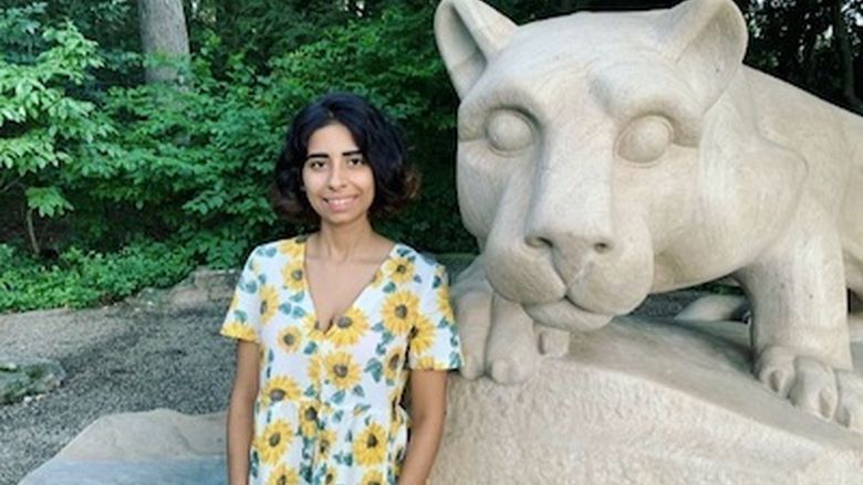 Photo of Harman Singh posing in front of Nittany Lion statue