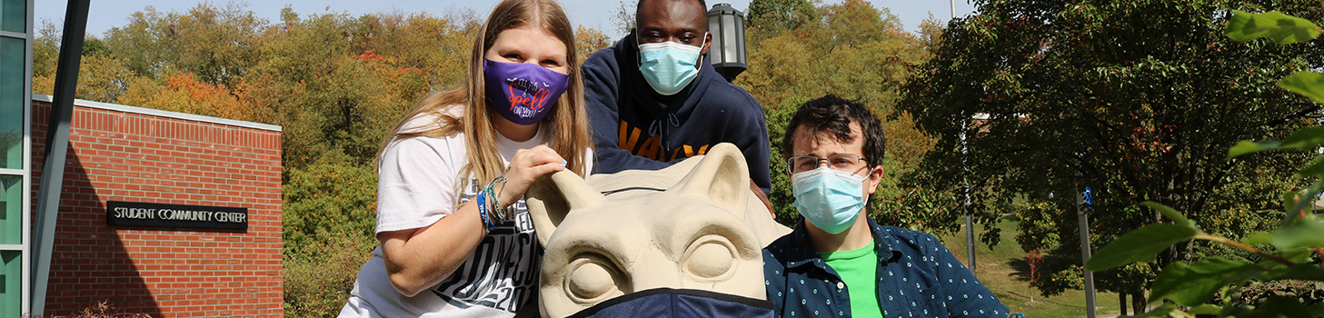 Students around the masked lion shrine.