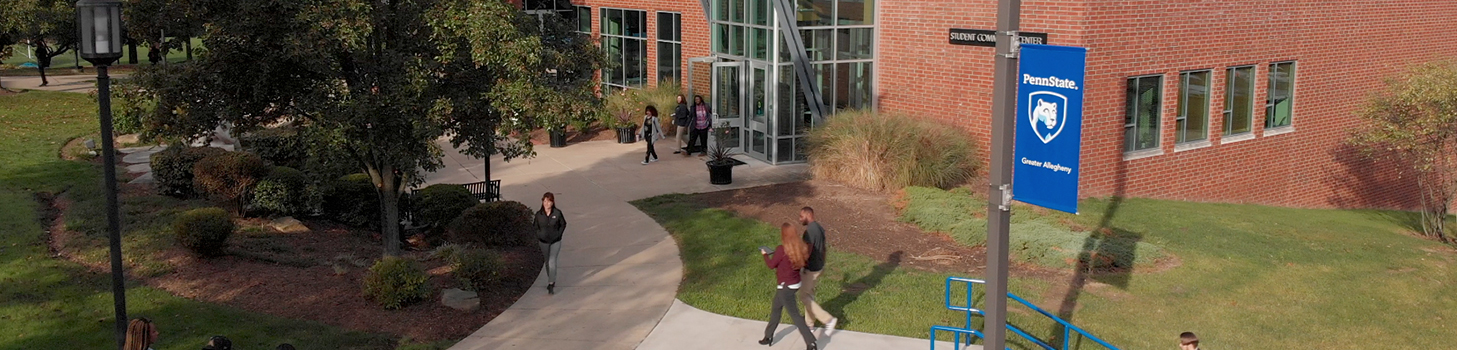 Students walking in front of the Student Community Center. 