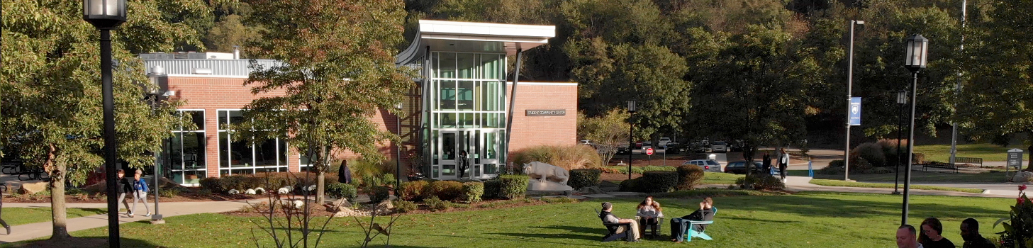 Students sitting in chairs in front of the Lion Shrine on Greater Allegheny's Campus