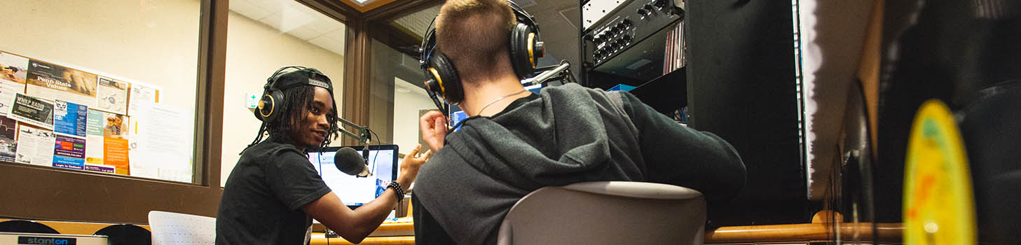 Students talking to each other in the campus's radio station