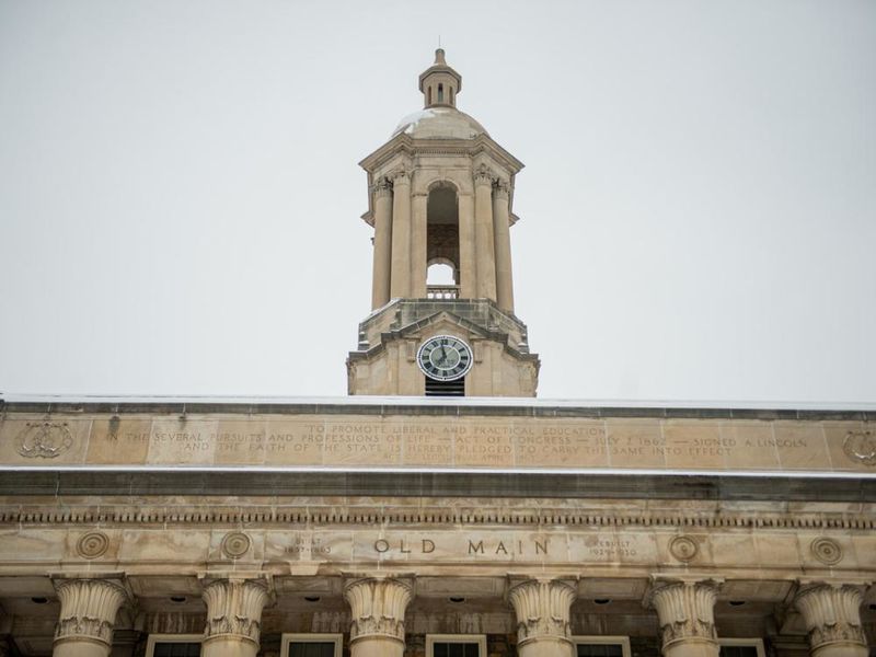 Tower of campus building with grey skies in background.