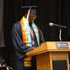 Graduate smiling at a podium