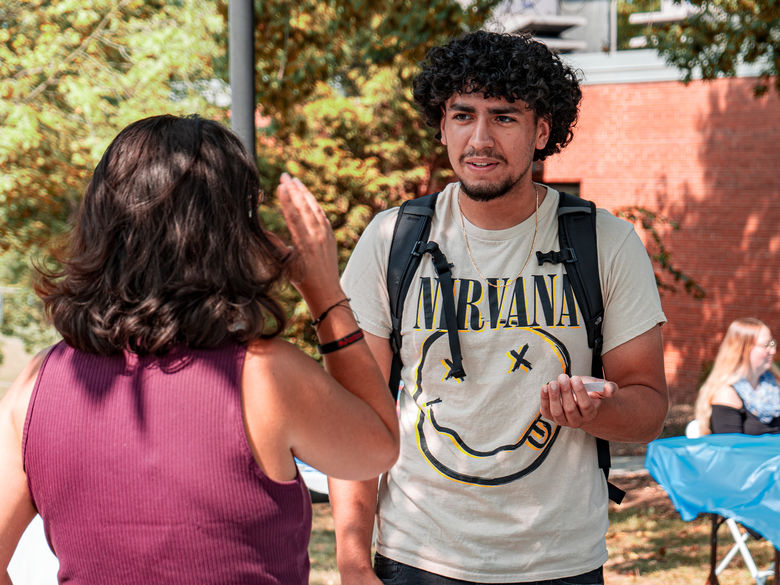 Student speaks with faculty member