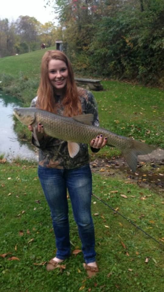 student holding large fish