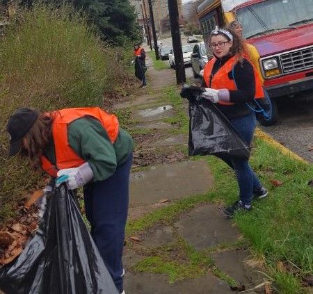 students helping to clean up streets