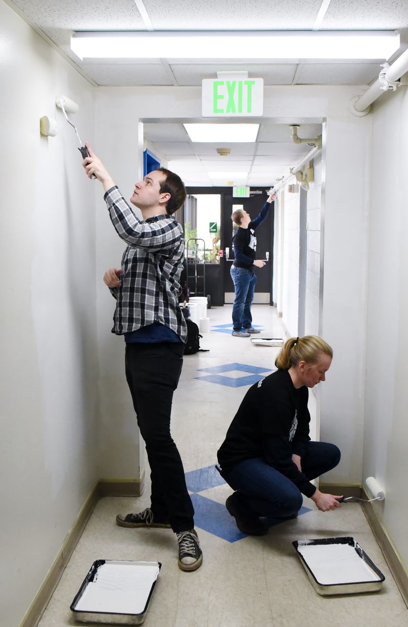 Two Penn State Behrend students paint a hallway during a MLK Day service project.