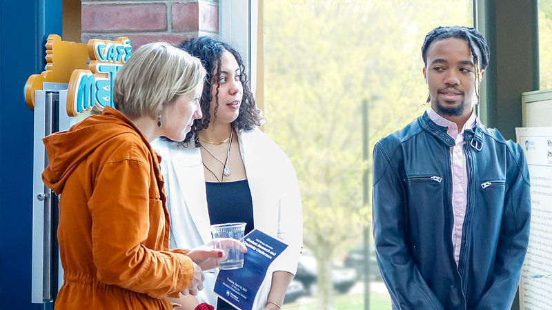 People presenting posters at a Research Conference