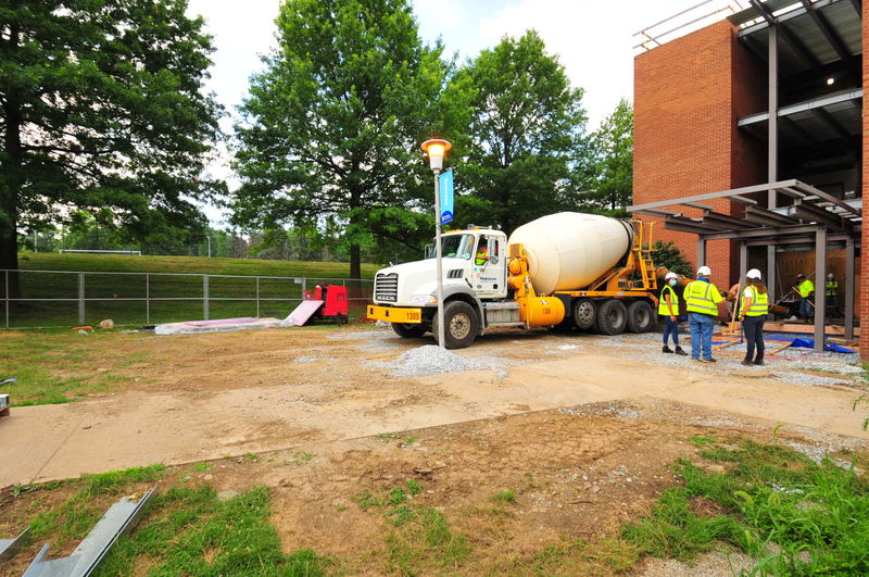 Cement truck pouring cement in front of Ostermayer Lab main entryway. 