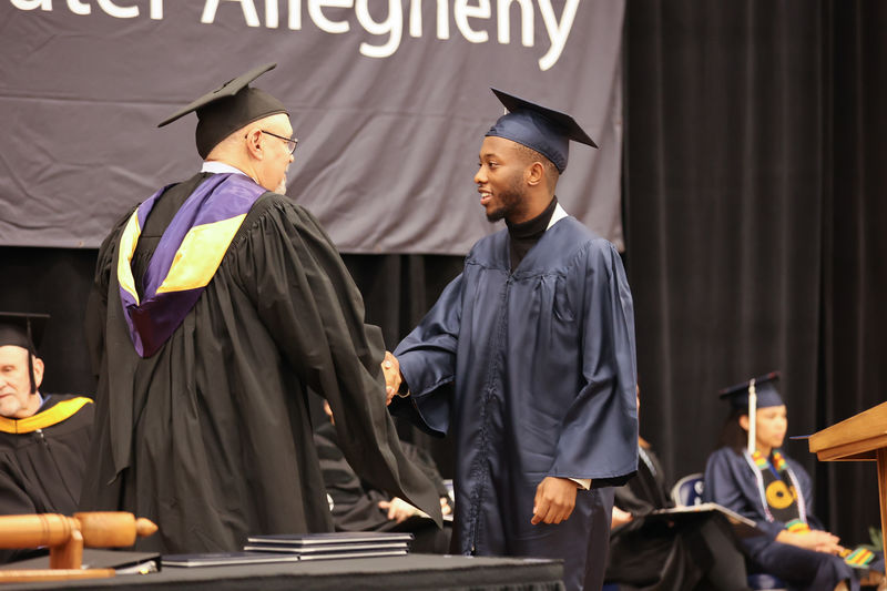 Information Sciences and Technology (B.S.) Degree Candidate, William Sosia, receiving his diploma