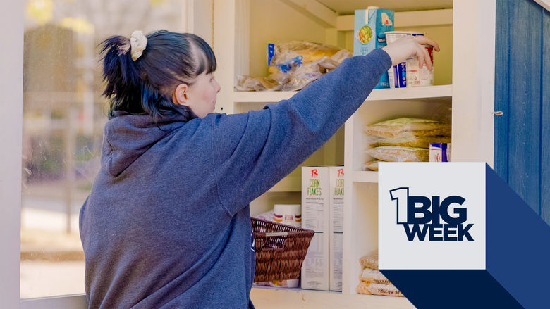 Student filling a food pantry on campus