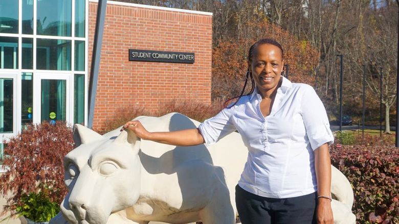 Woman standing by Greater Allegheny Lion Shrine