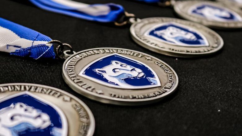 Penn State award medallions on a table 