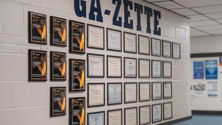 Interior building wall displaying framed awards