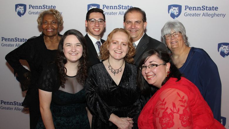 a group of people smiling at a camera