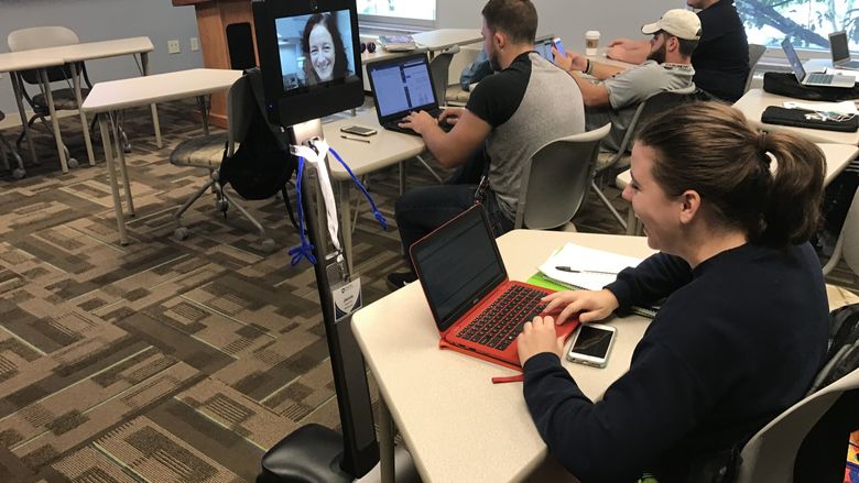 Students in class interact with robot