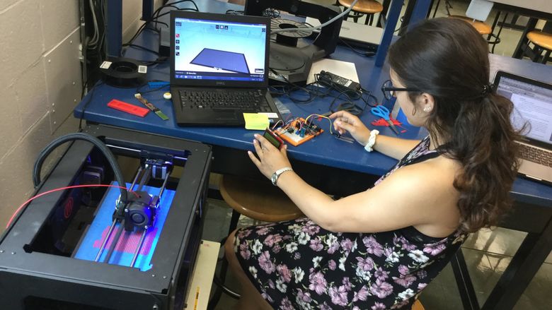 female student wroking with 3D printer