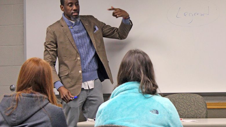 Man lecturing to students