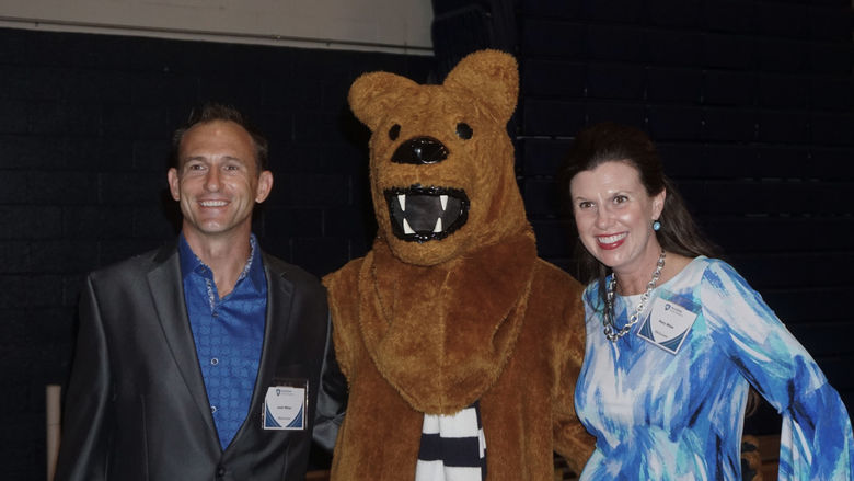 Lion Mascot standing next to guests