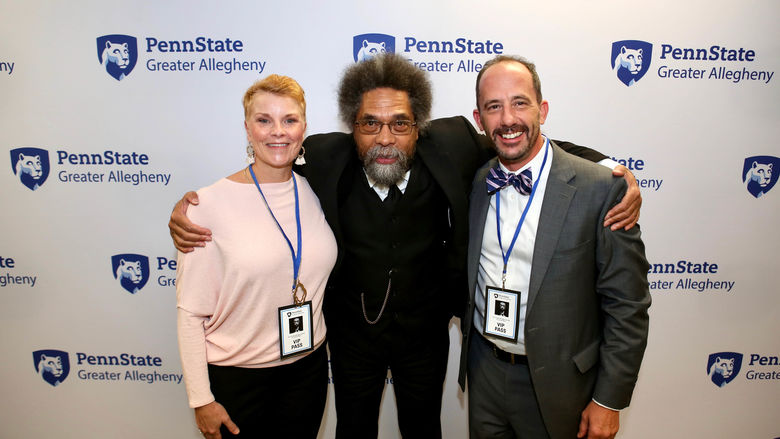 two men and a woman smiling at the camera