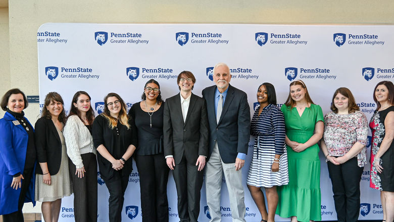 Student presenters at our internship showcase and breakfast gather with their site supervisors and faculty supervisors for a group photo