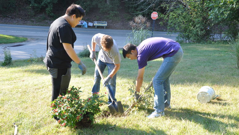 Students digging in campus garden