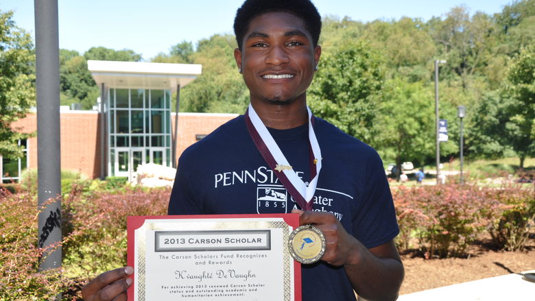 student holding certificate