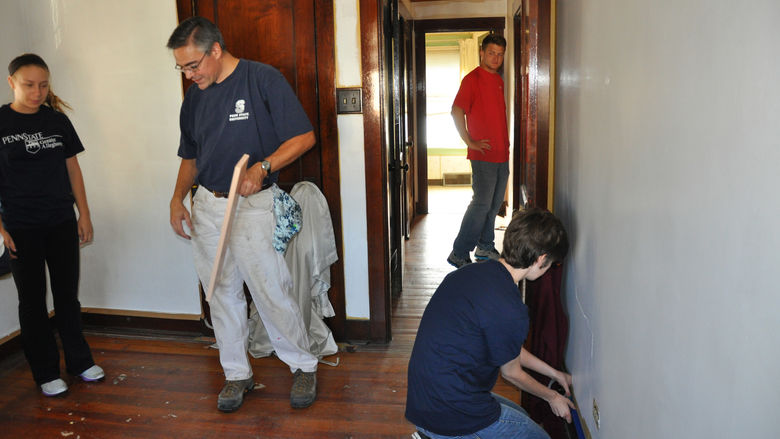 students working on  a house
