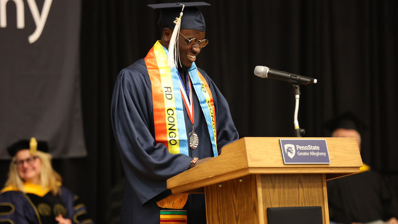 Graduate smiling at a podium
