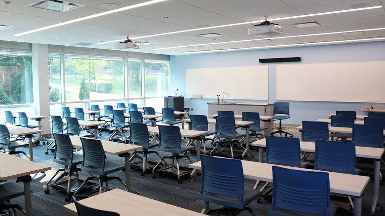 Classroom with tables, chairs, and whiteboards 