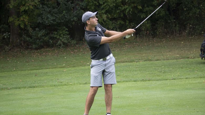 Guy Swinging Golf Club