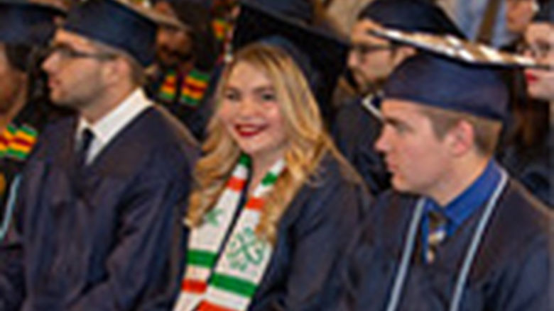 Students at graduation, girl smiling