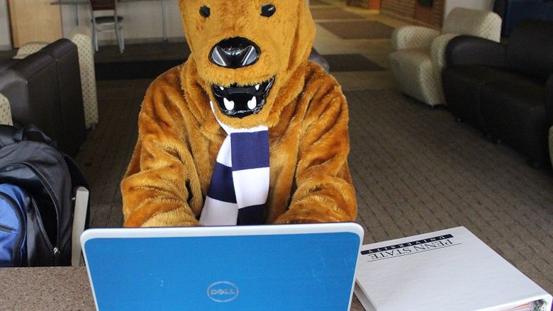 lion mascot at computer