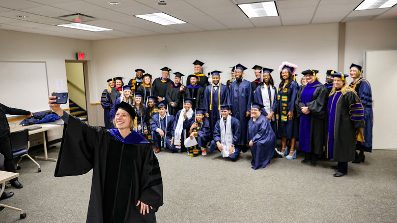 hind-the-scenes selfie celebrating our Fall Class of 2022 with Faculty and Interim Chancellor and Chief Academic Officer, Dr. Megan Nagel.