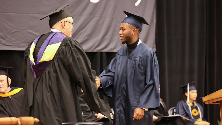 Information Sciences and Technology (B.S.) Degree Candidate, William Sosia, receiving his diploma