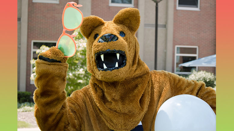 Nittany Lion mascot holding sunglasses and a beach ball 