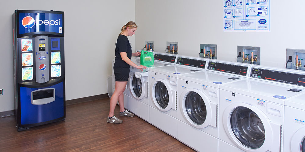 Student in on-campus laundry facility