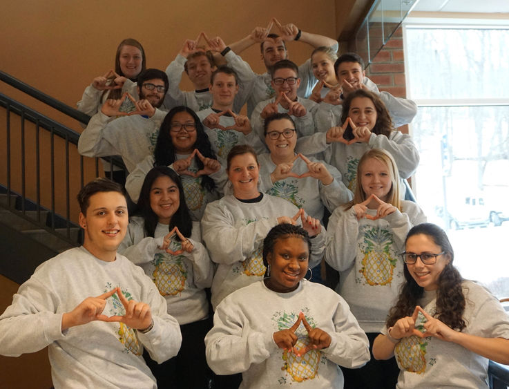 Be Greater THON Team smiling, making a diamond with their hands 