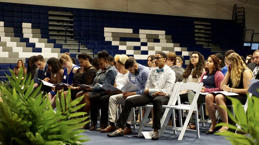 students sitting in chairs reading program