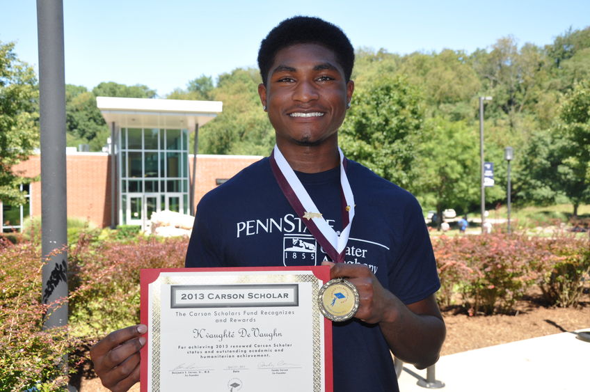 student holding certificate