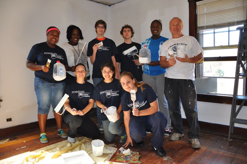 group of students with paint brushes