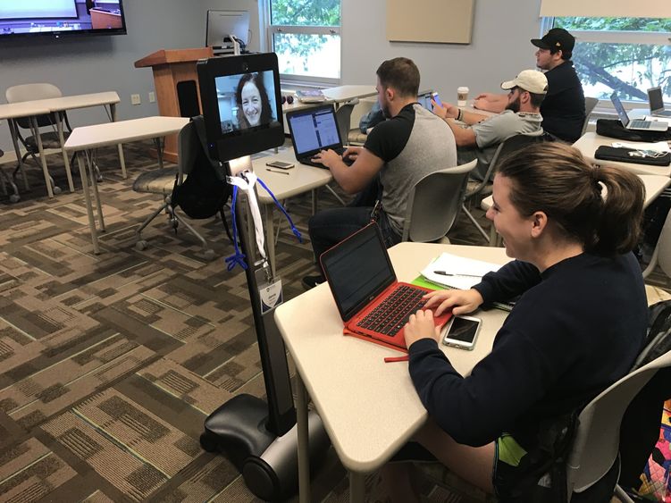 Students in class interact with robot