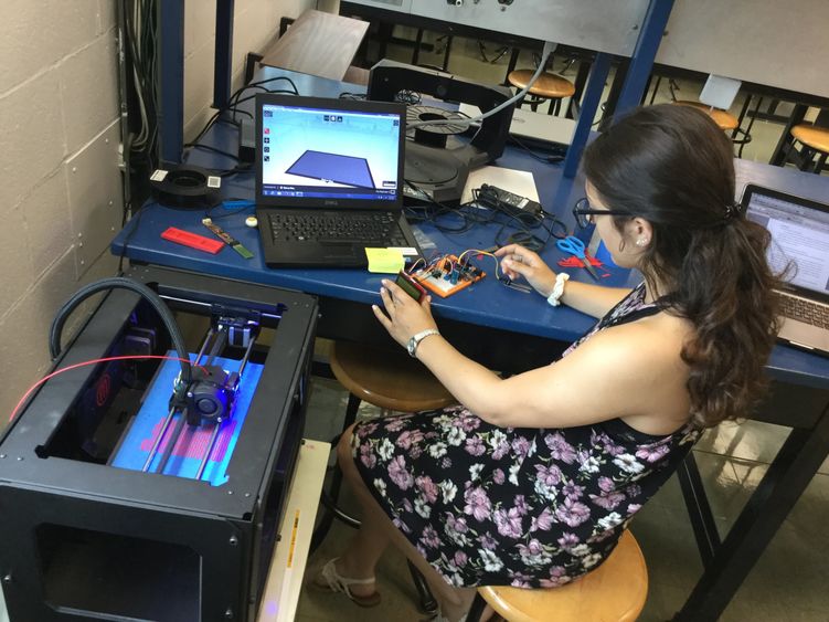 female student wroking with 3D printer