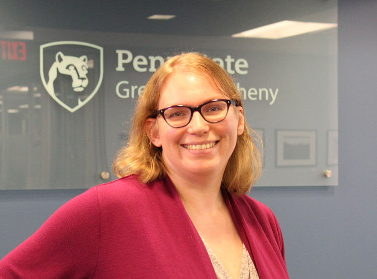 Beth Lindsey standing in front of Greater Allegheny Mark 