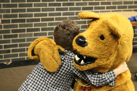 Nittany Lion Mascot giving hug to child