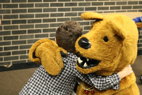 Nittany Lion Mascot giving hug to child 