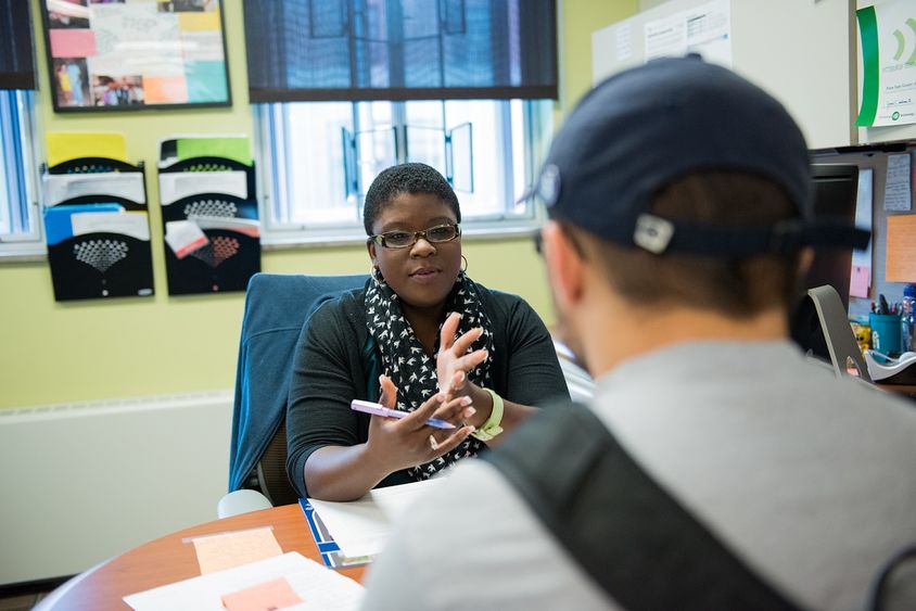 woman at desk with male student woman at desk with male student